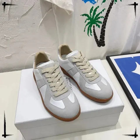 White and grey low-top sneakers placed on a shoe box in a W2C listing photo.