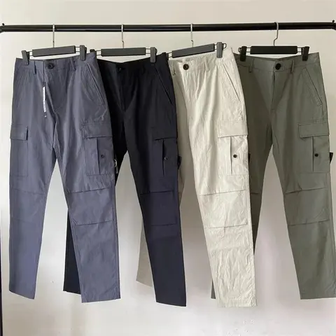 Four pairs of trousers hanging side by side in a W2C listing photo.