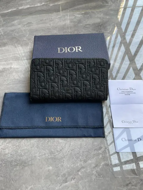 A dark patterned wallet and presentation pieces in a W2C listing photo.